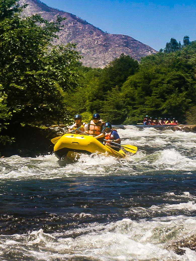 Adults whitewater rafting through Big Daddy rapid on the Kern River near Kernville California.
