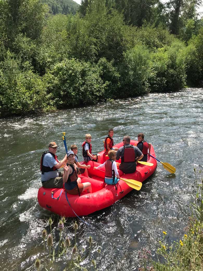 Youth group and Boy Scouts river rafting on the Provo River near Park City Utah.