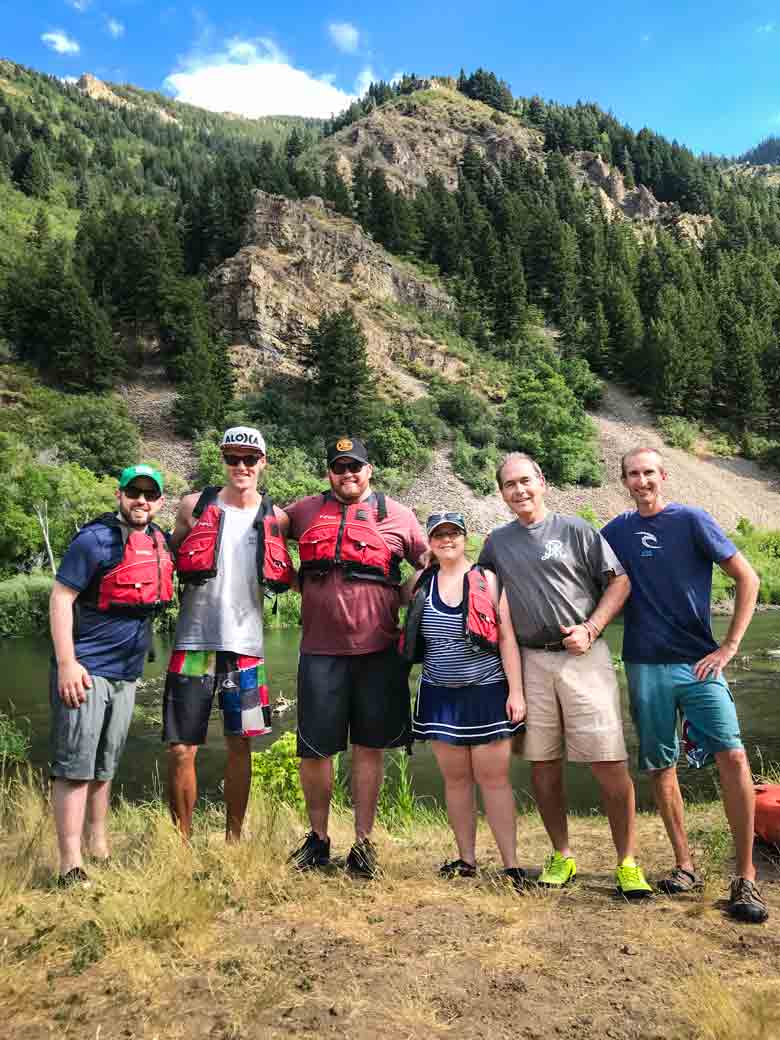 A group of people posing after a rafting and kayaking trip on the Provo River near Orem and Park City Utah.