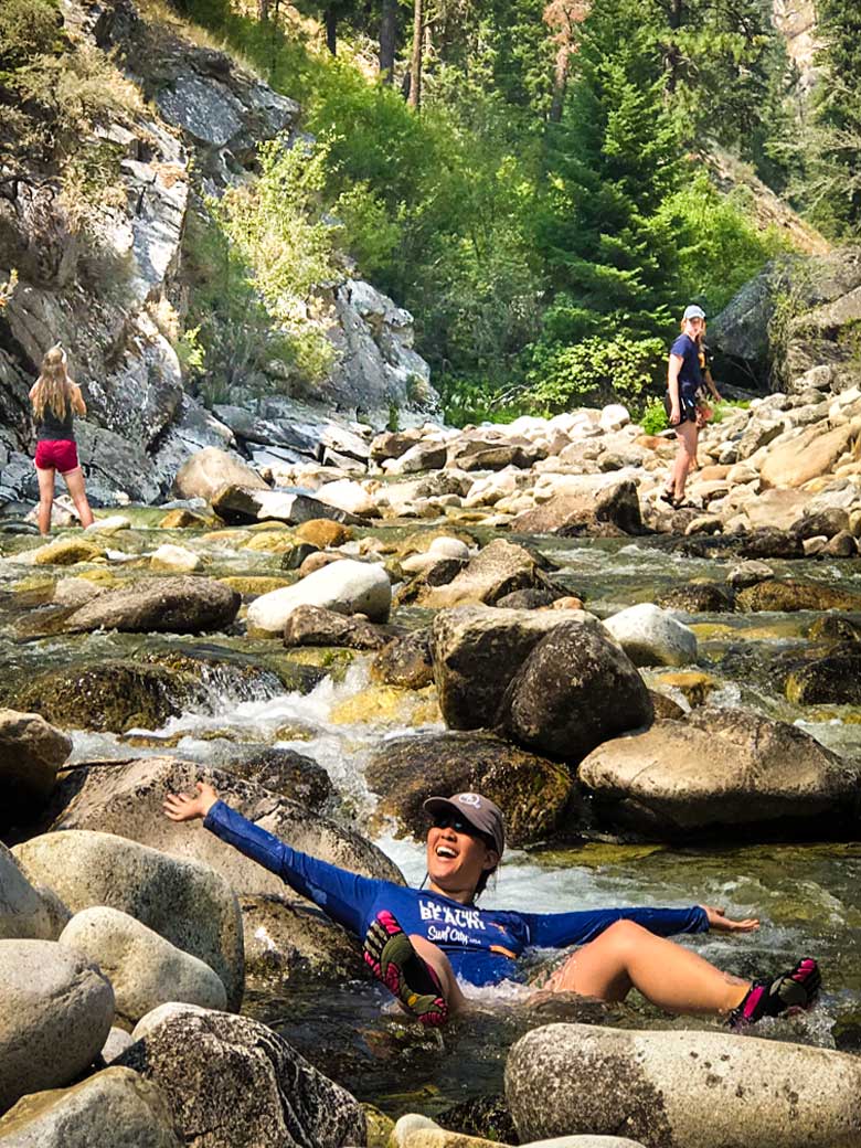 Three girls playing in a creek during a Main Salmon River Whitewater rafting vacation in Idaho.