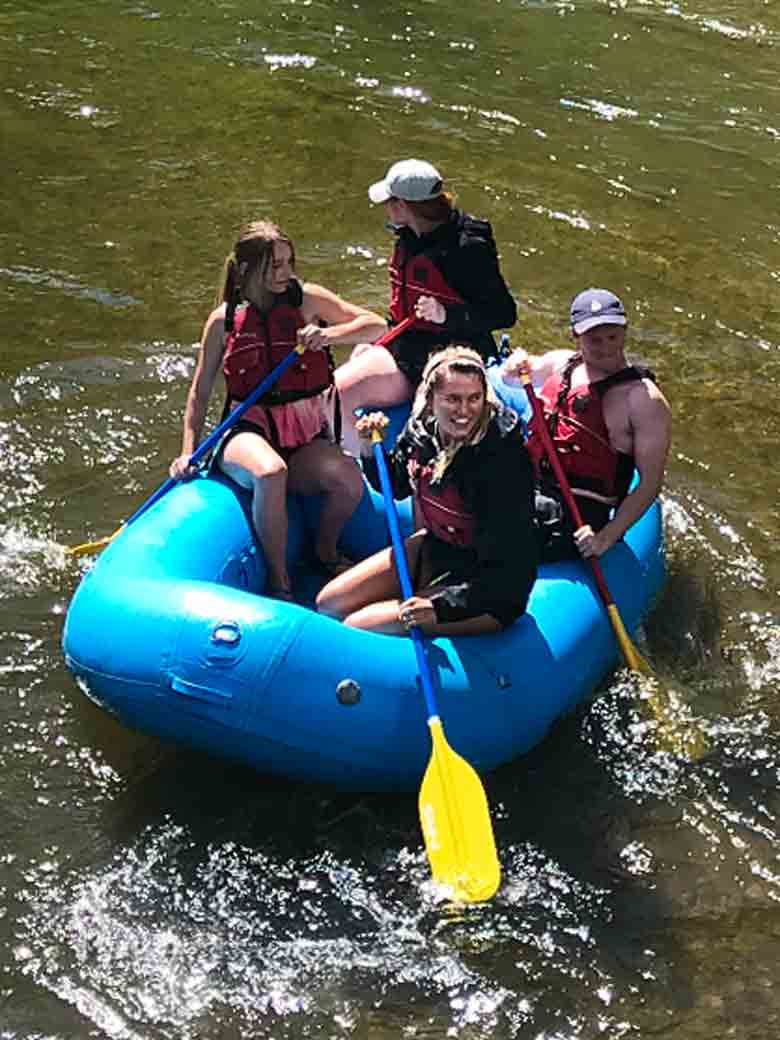 A group of four during a raft rental trip on the Provo River near Provo & Park City, Utah.