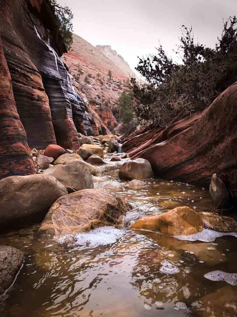 The slot canyons and creeks run suddenly, fast and deep in canyon country in Southern Utah. This view is from near Zion National Park.