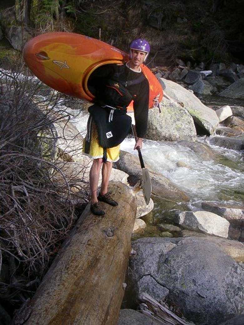 Donny carrying his kayak on the Strawberry to Kyburz run on the South Fork of the American River, California.