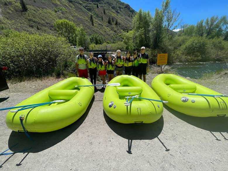 Groups standing in front of the rafts for a Provo River adventure near Bridal Veil Falls