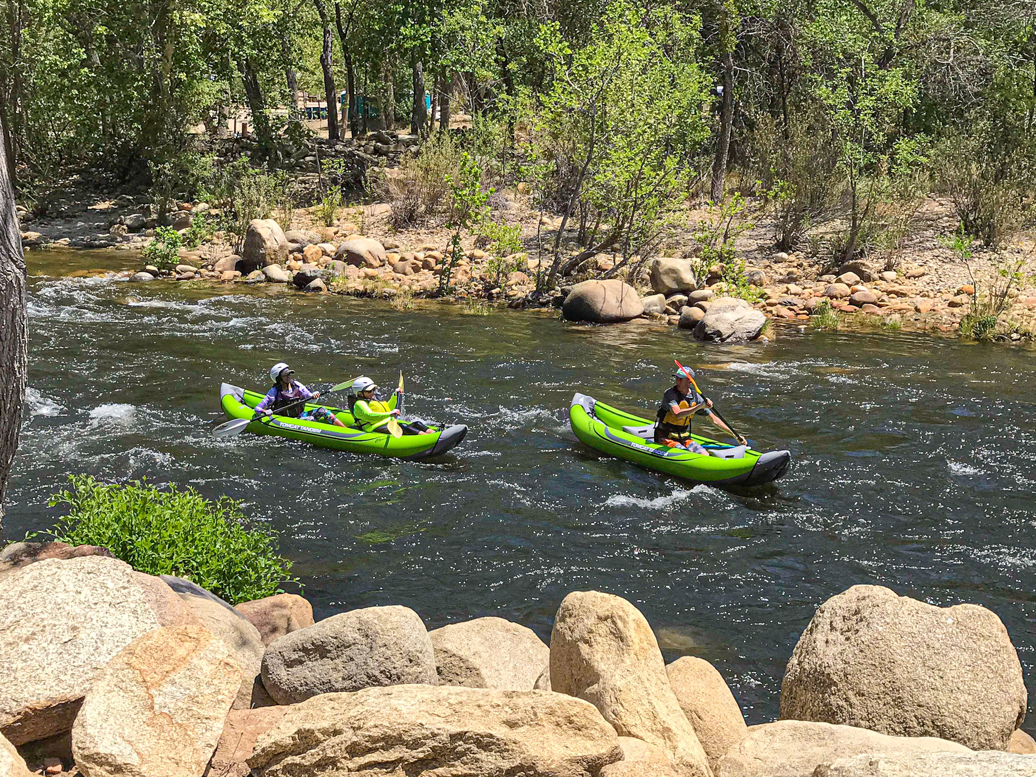 A group floating the Kern River with kayaks they rented from Kern River Rentals.